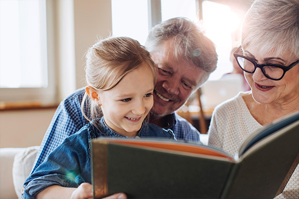 Grandparents reading to grandchild